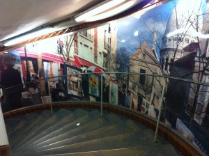 Spiral staircase lined with murals