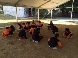 if water duties are finished in time, the kids get to go to school - no pencil or paper, so the kids write with their fingers in the sand