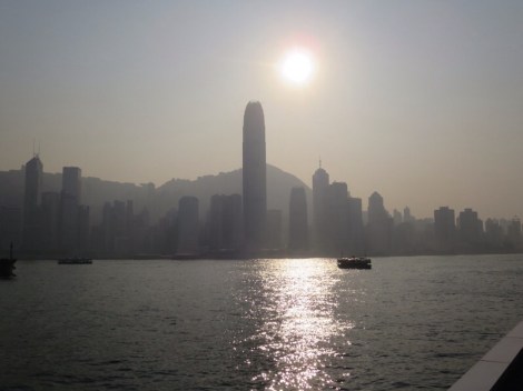 the sun begins to set over the hong kong skyline