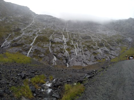 cliffs streaming with waterfalls lined both sides of the road